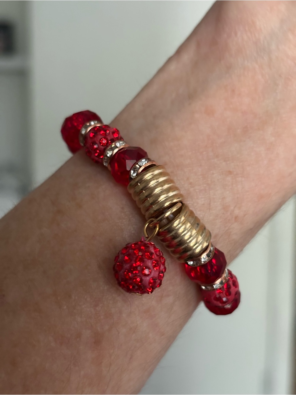 Red Beaded Stretch Bracelet with Gold Accents and Dangling Charm